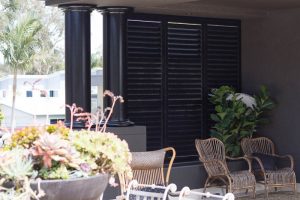 Dark Brown Plantation Shutters in Sitting Area - closed